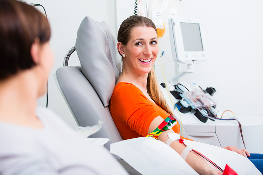 Woman smiling while giving blood