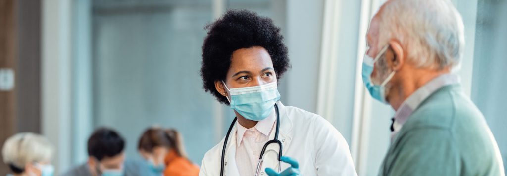 Doctor interacting with older white patient